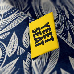A vibrant Yeet Seat label on a bean bag side