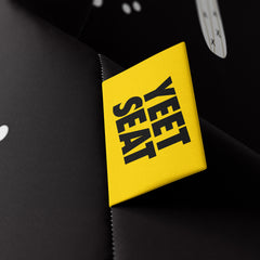 A vibrant Yeet Seat label on a bean bag side