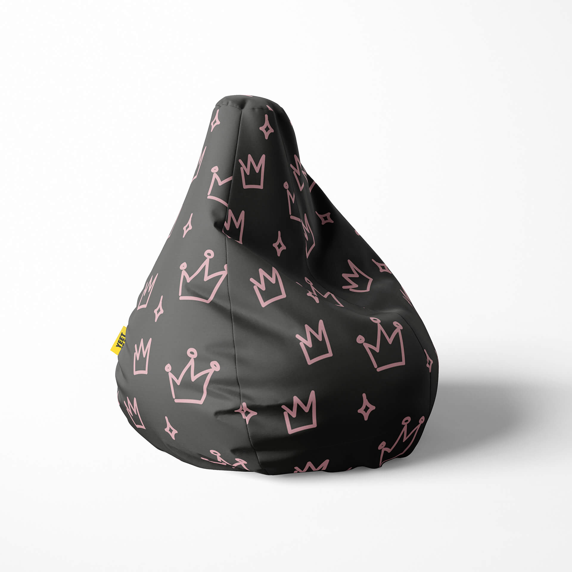 Right image of a beanbag with pink crowns and stars on a dark background.