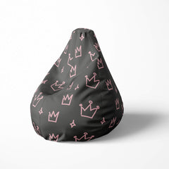 Left image of a beanbag with pink crowns and stars on a dark 