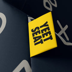 A vibrant Yeet Seat label on a bean bag side
