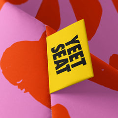 A vibrant Yeet Seat label on a bean bag side