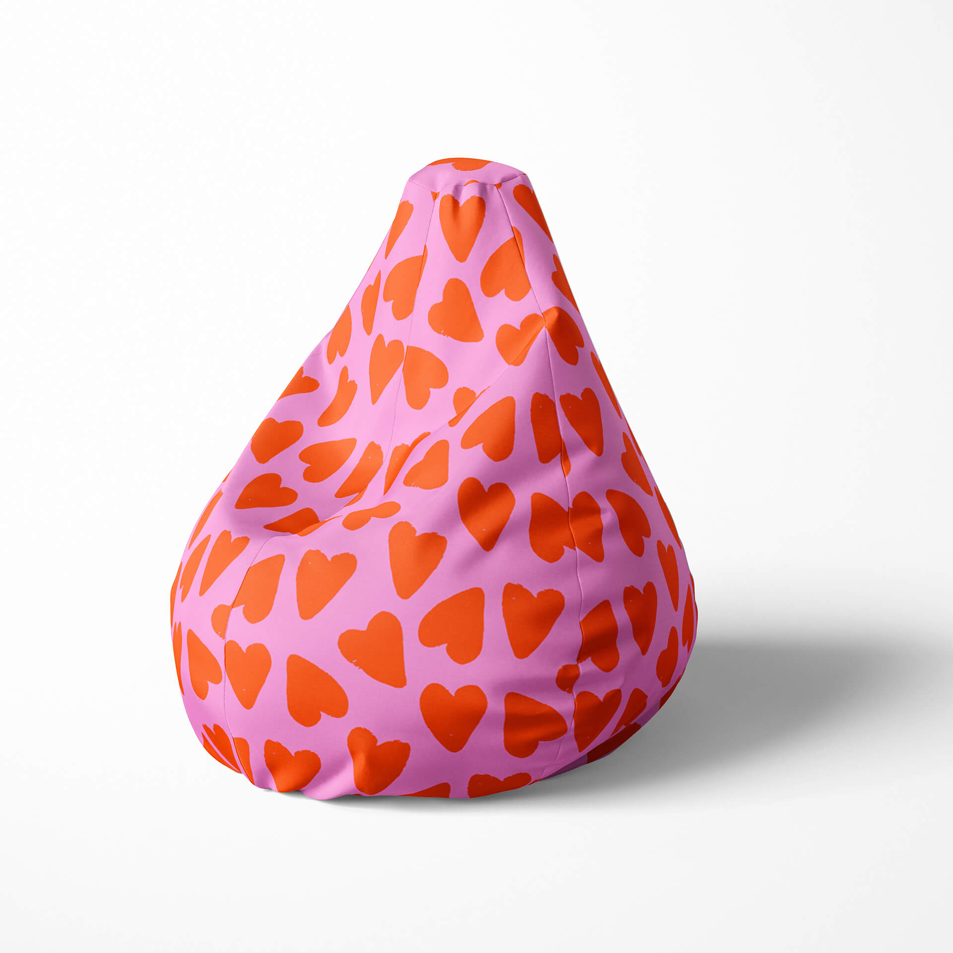 A left image of a pink and red heart beanbag on a white background