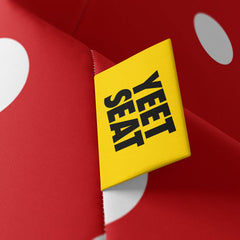 A vibrant Yeet Seat label on a bean bag side