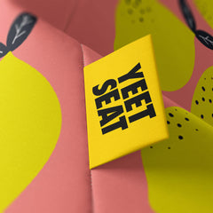 A vibrant Yeet Seat label on a bean bag side.