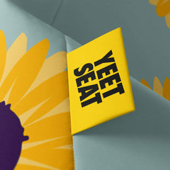 A vibrant Yeet Seat label on a bean bag side