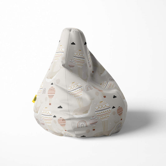 Right image of a beanbag with hot air balloons and clouds on a beige background.